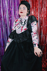 Women's vintage 1980's sleeveless off the shoulder ankle length black colored prom dress. Has a ruffled collar with all over silver metallic polka dots.