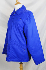 Men's or women's vintage 1980's Designer's Sportswear label long sleeve bright blue colored nylon material puffer jacket with side pockets.