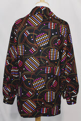 Women's vintage 1970's long sleeve button up blouse in black with all over multi-colored abstract print in a lightweight polyester material.