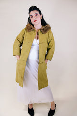 Women's vintage 1960's long sleeve long length button up suede coat with fur trim on collar. Mustard yellow color. Has pockets and side slits.