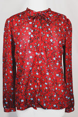 Women's vintage 1970's Donnkenny label long sleeve button up blouse with an attached tie neck. Red with all over blue ditsy floral print.