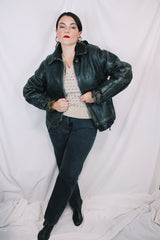 Men's vintage unknown, maybe around 40's-50's long sleeve black distressed leather jacket with zipper front closure and buckles on cuffs.