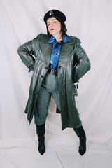 Men's or women's vintage 1970's Made in Argentina label knee length dark grey colored leather trench coat with double lapel and button closure.