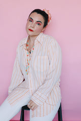 Women's or men's vintage 1970's Sears The Men's Store, Made in Japan label long sleeve button up shirt in white with all over orange vertical stripes.