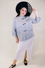 Women's vintage 1960's The Original Stork-A-Lure label long sleeve grey stain jacket with all over print. Black buttons up the front and mandarin collar.