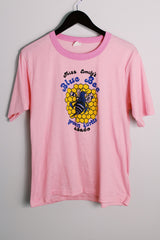 Women's vintage 1970's Chippie, Made in Bahamas label short sleeve bubblegum pink tee with a yellow and blue bee graphic on the front with a contrast trim.