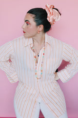 Women's or men's vintage 1970's Sears The Men's Store, Made in Japan label long sleeve button up shirt in white with all over orange vertical stripes.