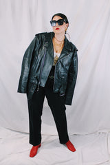 Men's vintage 1980's black genuine leather zip up motorcycle style jacket. All over silver hardware, popper buttons, and and zippers.