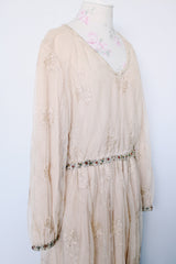 Women's vintage 1960's ankle length cream dress with lace overlay that has gold metallic detail. Beaded belt and beaded cuffs.