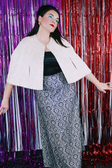 Women's vintage 1970's short length white furry faux fur white poncho sweater. Has button closure in the front and slits for arms