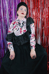 Women's vintage 1980's sleeveless off the shoulder ankle length black colored prom dress. Has a ruffled collar with all over silver metallic polka dots.