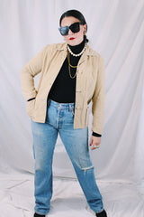 Women's vintage 1960's Union Made, Genuine Heeksuede Made in Holland label long sleeve short length tan colored suede button up lightweight jacket. Two front pockets and pink liner.