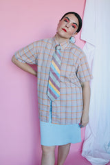 Men's or women's vintage 1970's The Fox, JCPenney label short sleeve button up shirt in yellow, grey, blue, and mauve all over plaid print. Tortoise colored buttons.