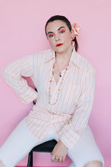 Women's or men's vintage 1970's Sears The Men's Store, Made in Japan label long sleeve button up shirt in white with all over orange vertical stripes.