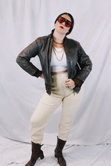 Men's or women's vintage 1950's Genuine Horsehides All Weather Garment, San Francisco, California label long sleeve brown leather bomber jacket with ribbed knit trim and quilted liner.