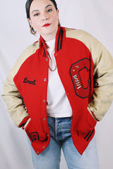 Men's vintage 1987 Nelson's Jackets, Portland, Oregon label long sleeve cream and red colored varsity letterman jacket in wool and nylon material. Has patches and pins.