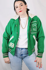 Women's vintage 1989 Nelson's Jacket, Portland, Oregon label bright green wool varsity letterman jacket with white trim. Has snap buttons, patches, pockets, and a hood. Shop more vintage outerwear and sportswear at Live Forever Vintage.