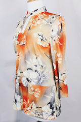 Women's vintage 1970's Pykettes label long sleeve floral printed tunic blouse with keyhole cut out front closure in grey, orange, and cream colors.