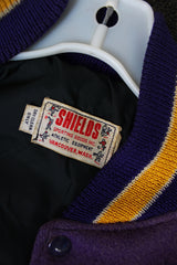 Women's or men's vintage 1960's Shields, Sporting Goods Inc., Vancouver, Washington label long sleeve wool and leather varsity letterman jacket in purple, cream, and yellow colors.