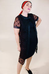 Women's vintage 1960's short sleeve mini length black dress with lace overlay and ribbon trim and bow. Zipper in the back.