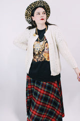 Women's vintage 1970's long sleeve cream colored button up acrylic sweater with scalloped edges on hem and cuffs.