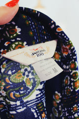 Men's or women's vintage 1970's Jantzen 100, Made in USA label long sleeve button up shirt in vibrant navy blue with all over orange, green, and white floral print.