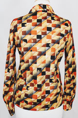 Women's vintage 1970's long sleeve button up shirt with dagger collar and all over brown and orange abstract print.