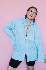 Men's vintage 1970's After Six Accessories label long sleeve blue colored tuxedo shirt with front chest ruffles. Openings for cuff links and studs.