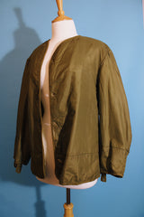 Men's or women's vintage 1950's long sleeve reversible army liner jacket. One side is a nubby cream color and one side is green Nylon.