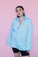 Men's vintage 1970's After Six Accessories label long sleeve blue colored tuxedo shirt with front chest ruffles. Openings for cuff links and studs.