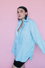 Men's vintage 1970's After Six Accessories label long sleeve blue colored tuxedo shirt with front chest ruffles. Openings for cuff links and studs.