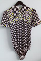 Women's vintage 1970's short sleeve puff sleeve bodysuit with collar in a black and purple checkered print and florals.