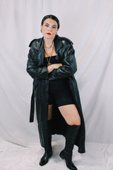Men's or women's vintage 1980's Vakko Sport, Made in USA label long sleeve long length black leather trench coat. Double breasted closure, shoulder pads, and matching tie belt.
