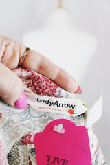 Women's vintage 1970's Lady Arrow label long sleeve half button closure tunic blouse with an all over pin, blue, and grey novelty print.