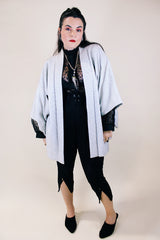 Women's vintage 1960's long sleeve textured kimono. Baby blue color with blue and white floral liner. Ties in the front. Wide big sleeves.