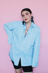 Men's vintage 1970's After Six Accessories label long sleeve blue colored tuxedo shirt with front chest ruffles. Openings for cuff links and studs.