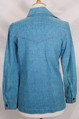 Women's vintage 1970's long sleeve medium wash denim chambray button up blouse with red contrast stitching and brass buttons.