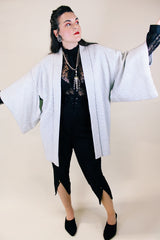 Women's vintage 1960's long sleeve textured kimono. Baby blue color with blue and white floral liner. Ties in the front. Wide big sleeves.