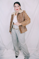 Men's or women's vintage 1970's light tan brown suede leather jacket with cream soft shearling liner. Zipper front closure and side pockets.