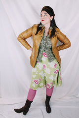 Women's vintage 1970's Made in Belgium label long sleeve light tan colored leather lightweight jacket with silver snap buttons and a dagger collar.