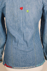 Women's vintage 1970's Montgomery Ward label long sleeve medium wash denim chambray top with snapper buttons.