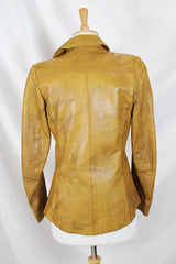 Women's vintage 1970's Made in Belgium label long sleeve light tan colored leather lightweight jacket with silver snap buttons and a dagger collar.