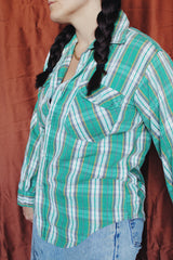 Women's or men's vintage 1970's Montgomery Ward label long sleeve button up flannel shirt in green and white plaid print.