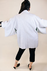 Women's vintage 1960's long sleeve textured kimono. Baby blue color with blue and white floral liner. Ties in the front. Wide big sleeves.