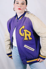 Women's or men's vintage 1960's Shields, Sporting Goods Inc., Vancouver, Washington label long sleeve wool and leather varsity letterman jacket in purple, cream, and yellow colors.