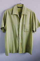 Men's vintage 1960's Sears label short sleeve button up shirt with collar and one left chest pocket in a lime green striped cotton material.