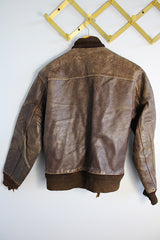 Men's or women's vintage 1950's Genuine Horsehides All Weather Garment, San Francisco, California label long sleeve brown leather bomber jacket with ribbed knit trim and quilted liner.