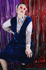 Women's vintage 1970's sleeveless dark blue crushed velvet knee length dress. Has a deep V shaped neckline in the front.