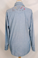 Men's vintage 1970's long sleeve chambray denim shirt with colored embroidery in the front and back.