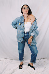 Men's or women's vintage 1980's Levi's medium wash denim lightweight jacket with brass hardware. Buttons up the front and four pockets. Size XXL.